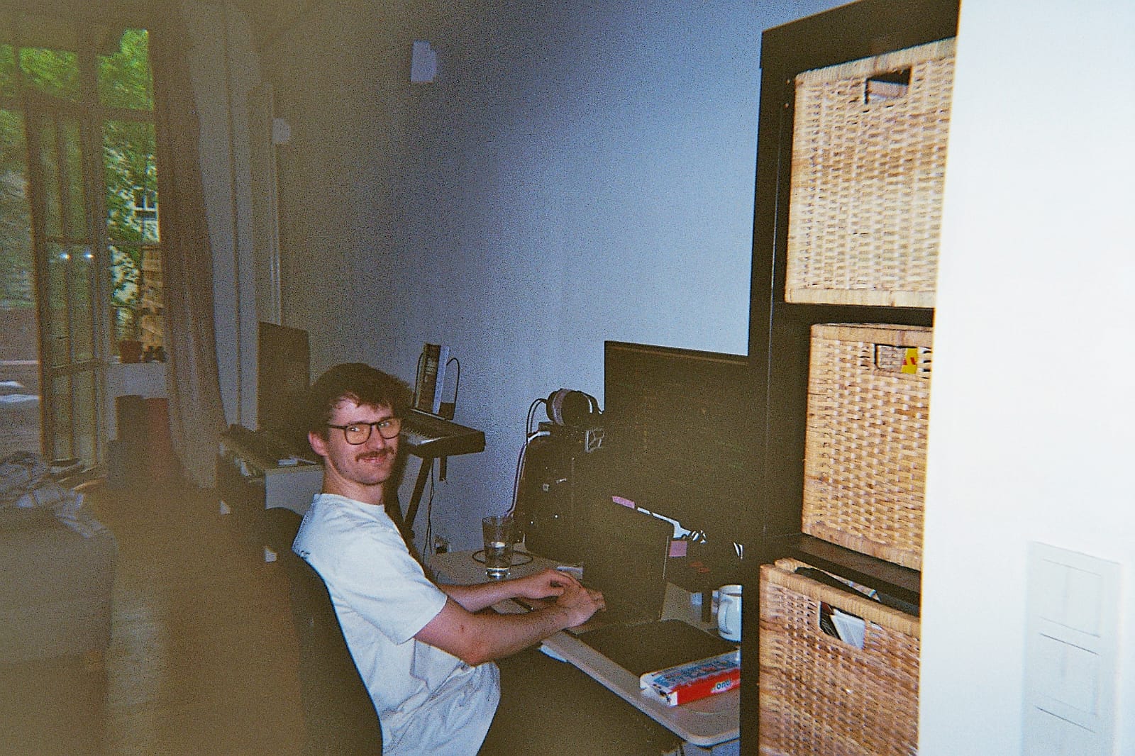 Conor at a desk, coding on a laptop